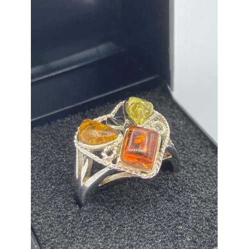 189 - AMBER and SILVER RING having having champagne, lime, and yellow AMBER  stones set to top in Silver m... 