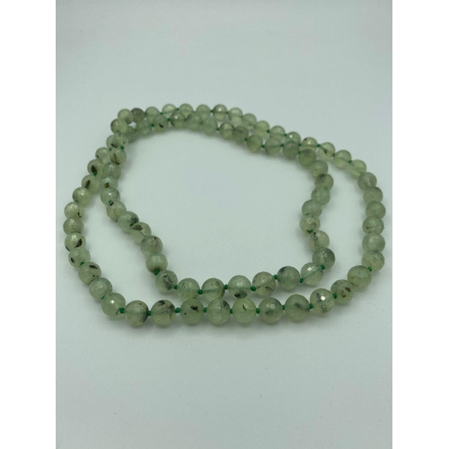 196 - Vintage long GREEN PREHNITE NECKLACE having individually knotted CHRYSOLITE orbs in 1920s style.
36”... 