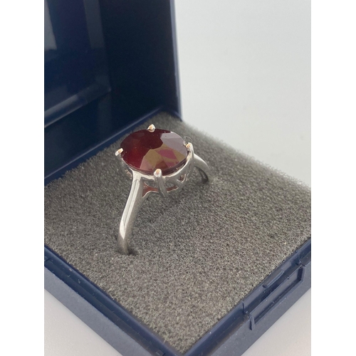 329 - SILVER RING having large RED TOURMALINE SOLITAIRE (3 carats) set to top. Markings inside band for 92... 