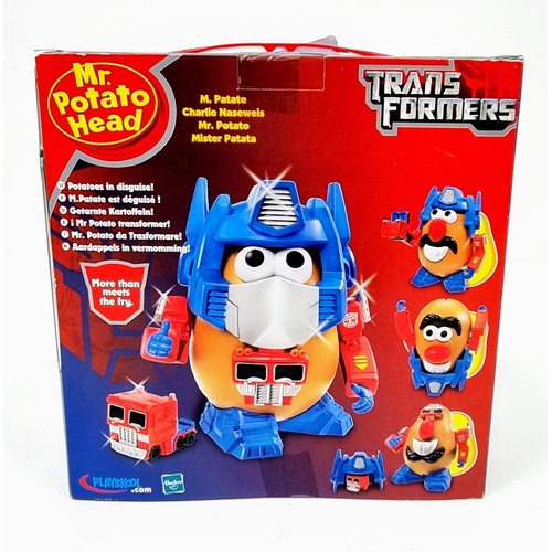 505 - Three Very Collectable Mr Potato Head Toys. To include: Elvis Live, Spider Spud and Transformers. As... 