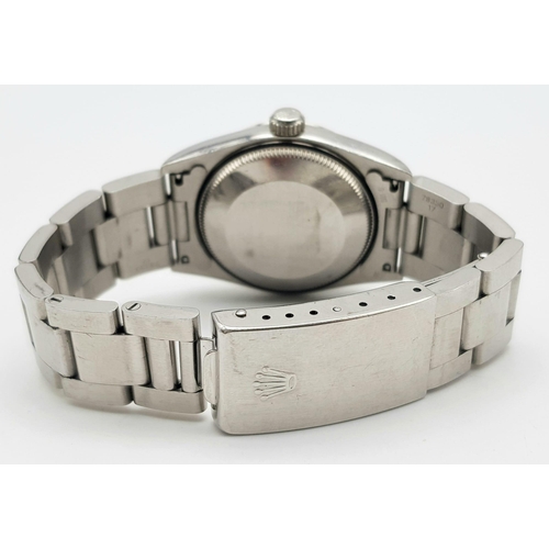 163 - A Rolex Oyster Perpetual Automatic Ladies Watch. Stainless steel strap and case - 30mm. Silver tone ... 