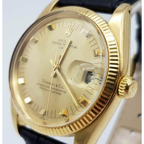 368 - A Rolex Oyster Perpetual Datejust Tiffany and Co 18K Gold Watch. Black leather strap. 18k gold case ... 