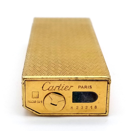 246 - A GOLD PLATED CARTIER FLIP TOP GAS LIGHTER .