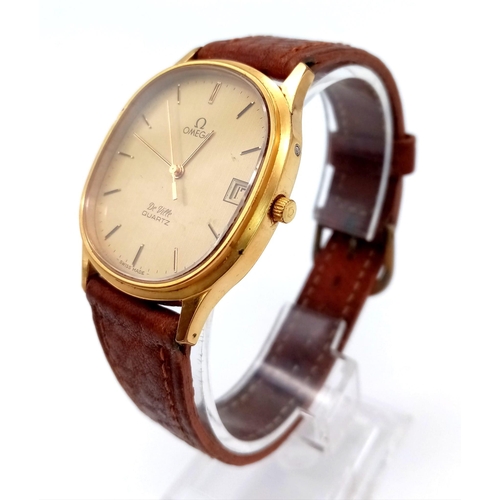 73 - An Omega Deville Quartz Gents Watch. Leather strap. Two tone case - 32mm. Gilded dial with date wind... 