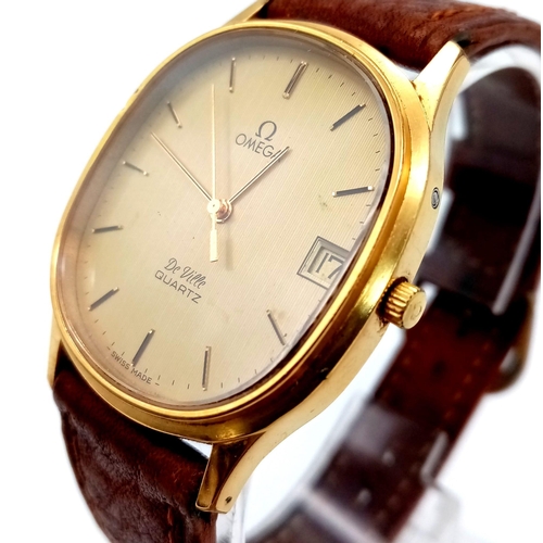 73 - An Omega Deville Quartz Gents Watch. Leather strap. Two tone case - 32mm. Gilded dial with date wind... 