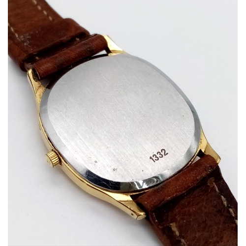 73 - An Omega Deville Quartz Gents Watch. Leather strap. Two tone case - 32mm. Gilded dial with date wind... 