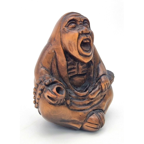 1107 - A Japanese Wooden Netsuke Figure. Marking on base. 5cm.