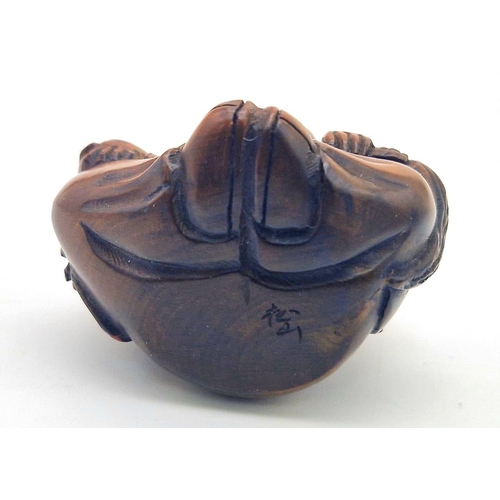 1107 - A Japanese Wooden Netsuke Figure. Marking on base. 5cm.