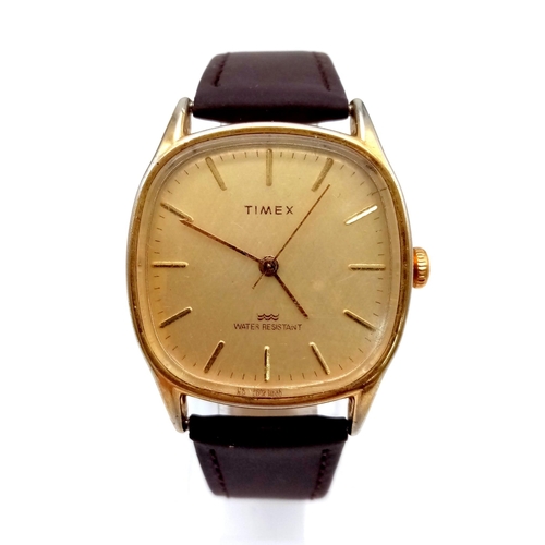 1295 - A Vintage Timex Quartz Watch. Brown leather strap. Gilded case - 32mm. In working order.