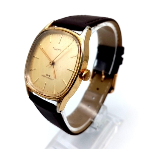 1295 - A Vintage Timex Quartz Watch. Brown leather strap. Gilded case - 32mm. In working order.