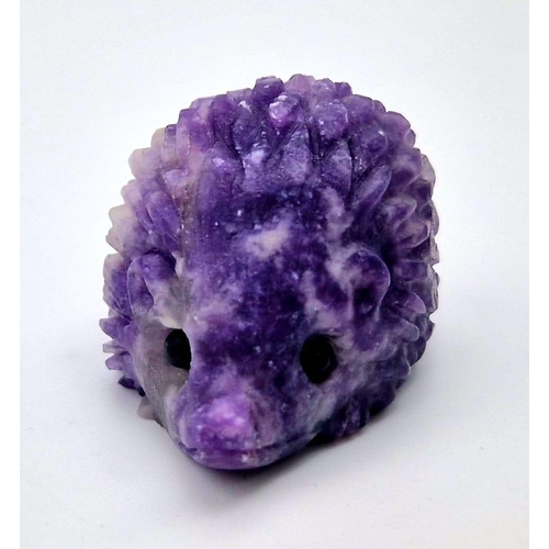 909 - A Hand-Carved Rainbow Flourite Hedgehog Figure. 5 x 2.5cm.