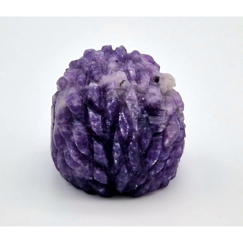 909 - A Hand-Carved Rainbow Flourite Hedgehog Figure. 5 x 2.5cm.