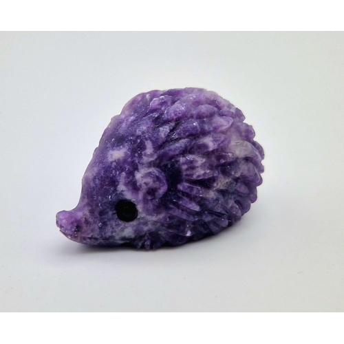 909 - A Hand-Carved Rainbow Flourite Hedgehog Figure. 5 x 2.5cm.