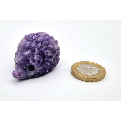 909 - A Hand-Carved Rainbow Flourite Hedgehog Figure. 5 x 2.5cm.