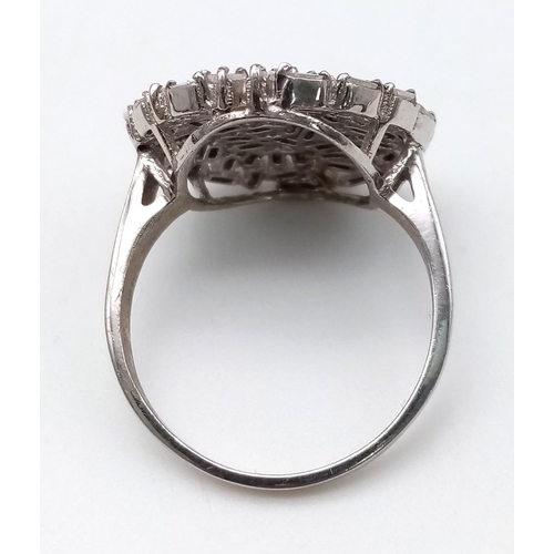 1125 - A 14 K white gold ring with numerous baguette cut diamonds. Size: S, weight: 5.14 g.