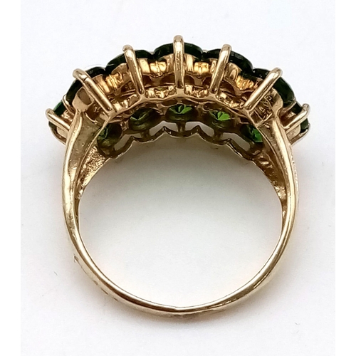 663 - A 9 K yellow gold ring with three rows of rose cut peridots. Size: L, weight: 4.25 g.