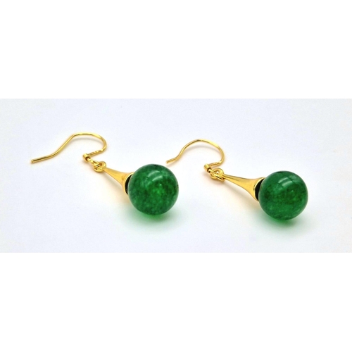 686 - A Pair of Jade Ball Earrings on Gilded Coronet Attachments.