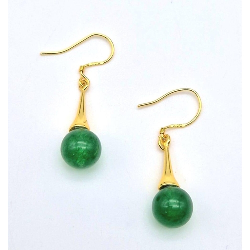 686 - A Pair of Jade Ball Earrings on Gilded Coronet Attachments.