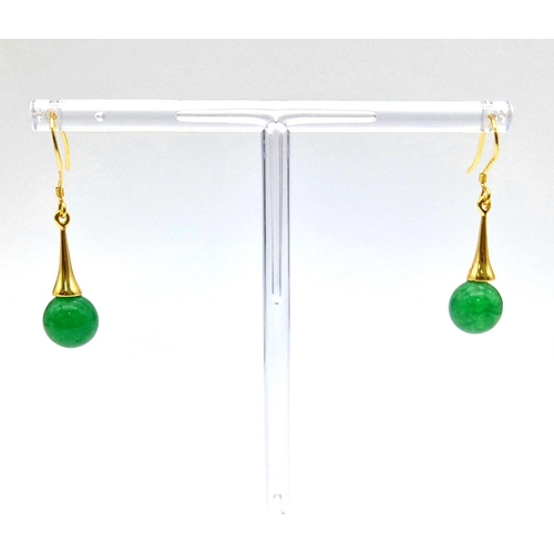 686 - A Pair of Jade Ball Earrings on Gilded Coronet Attachments.