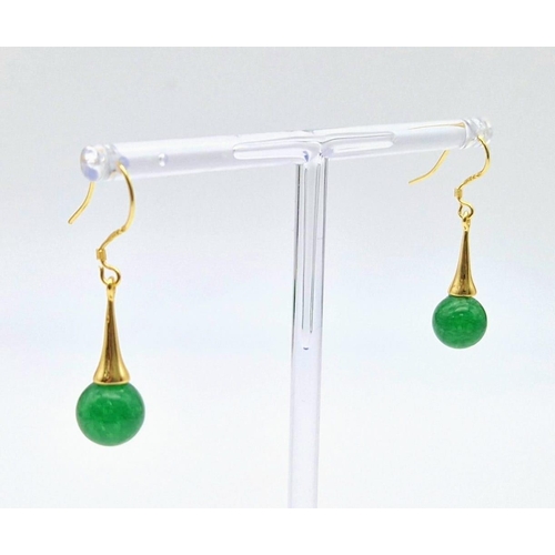 686 - A Pair of Jade Ball Earrings on Gilded Coronet Attachments.