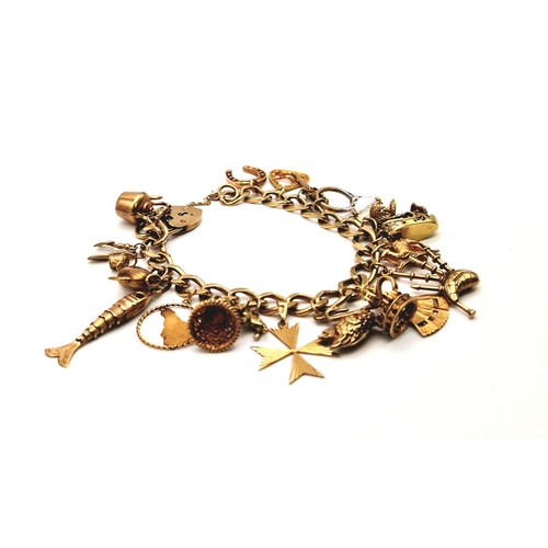 526 - A Vintage 9K Yellow Gold Charm Bracelet with a Heart Clasp and 21 gold charms. 45g total weight. 16c... 