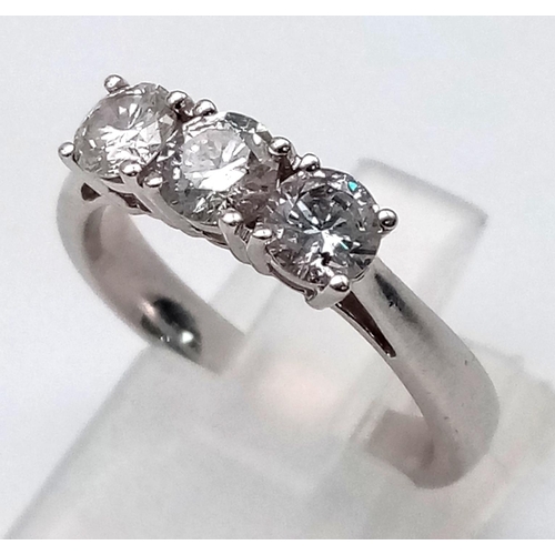 919 - An 18 K white gold ring with a trilogy of brilliant cut diamonds.  Size: M, weight: 4.3 g.