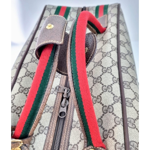 157 - A Gucci Ophidia Small Suitcase/Carry On. Gucci monogram canvas exterior. Red and green handles with ... 