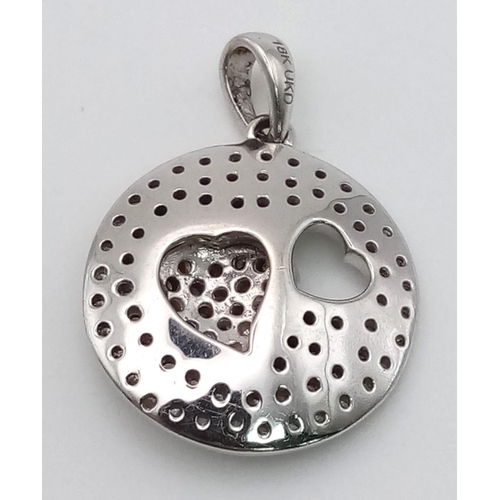 220 - An 18 K white gold pendant in the shape of a heart with diamonds (0.50 carats). weight: 3.9 g.