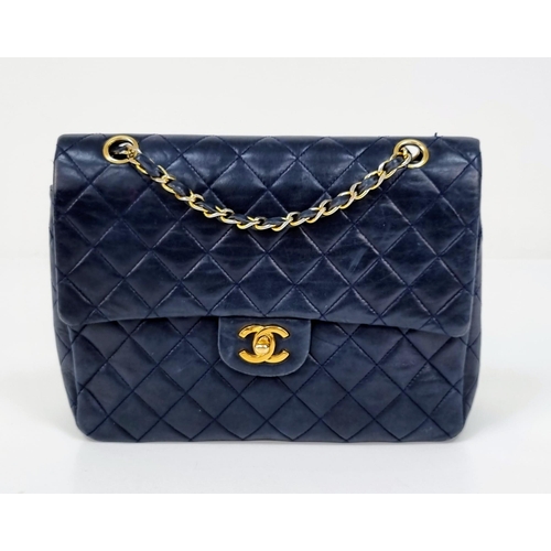 1 - A Classic Chanel Navy Blue Calfskin Flap Bag. Gilded hardware with the iconic Chanel clasp. Leather ... 