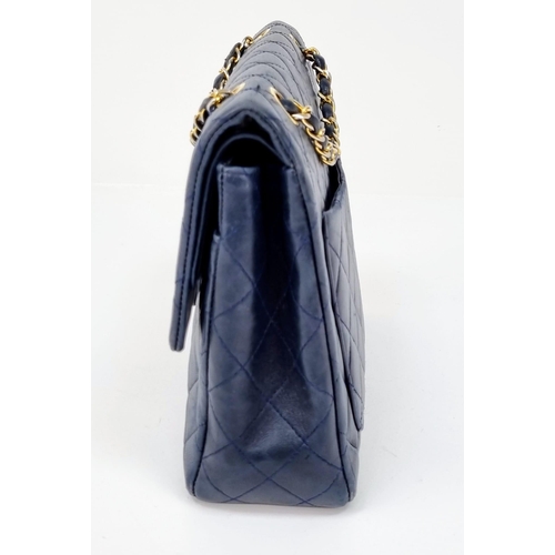 1 - A Classic Chanel Navy Blue Calfskin Flap Bag. Gilded hardware with the iconic Chanel clasp. Leather ... 