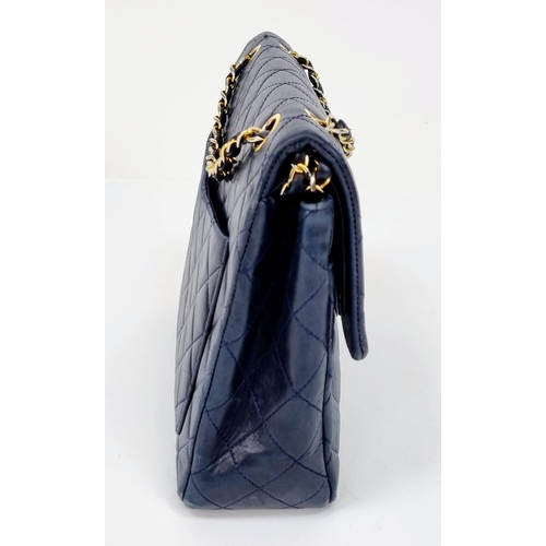 1 - A Classic Chanel Navy Blue Calfskin Flap Bag. Gilded hardware with the iconic Chanel clasp. Leather ... 