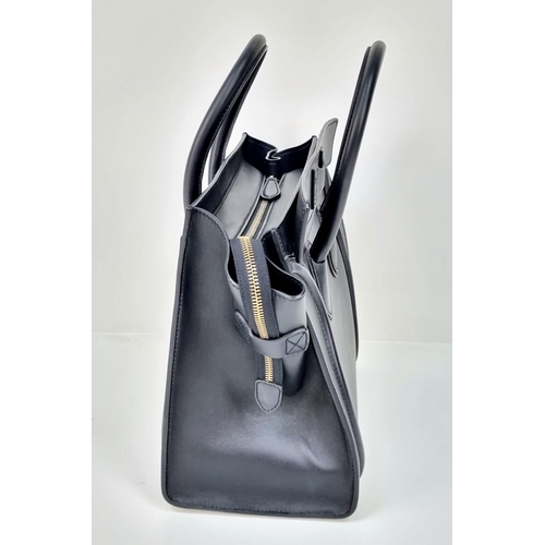 270 - A Celine of Paris Black Leather Small Tote Bag. Exterior pocket for convenience. Interior zipped and... 