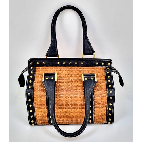 291 - A Wonderful Fendi Rattan Bag. Interwoven straw and leather exterior. Gilded studs throughout. Cloth ... 