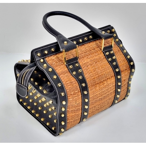 291 - A Wonderful Fendi Rattan Bag. Interwoven straw and leather exterior. Gilded studs throughout. Cloth ... 