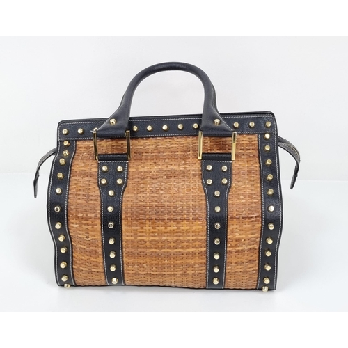 291 - A Wonderful Fendi Rattan Bag. Interwoven straw and leather exterior. Gilded studs throughout. Cloth ... 