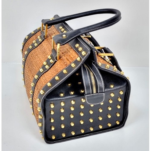 291 - A Wonderful Fendi Rattan Bag. Interwoven straw and leather exterior. Gilded studs throughout. Cloth ... 