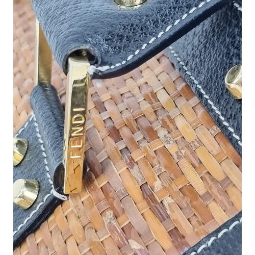 291 - A Wonderful Fendi Rattan Bag. Interwoven straw and leather exterior. Gilded studs throughout. Cloth ... 