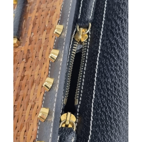 291 - A Wonderful Fendi Rattan Bag. Interwoven straw and leather exterior. Gilded studs throughout. Cloth ... 