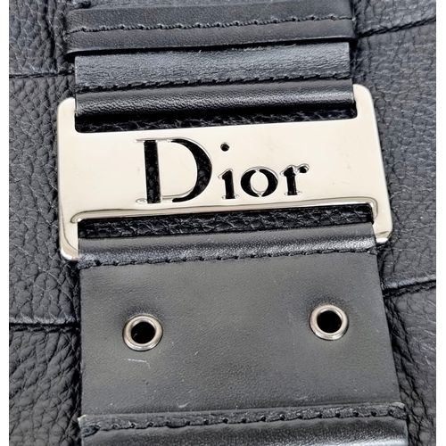 331 - A Christian Dior Street-Chic Hobo Bag in Black Grained Leather. Silver-toned hardware. Dior monogram... 