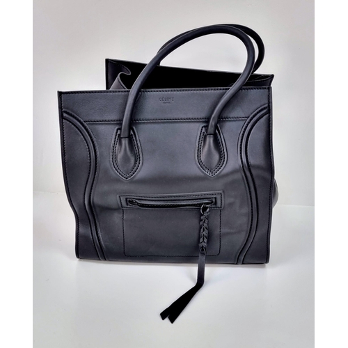 45 - A Celine of Paris Black Leather Tote Bag. Rich black leather exterior with a zipped compartment. Bla... 