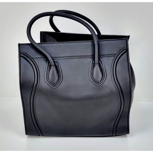 45 - A Celine of Paris Black Leather Tote Bag. Rich black leather exterior with a zipped compartment. Bla... 