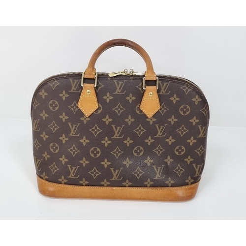 457 - A Louis Vuitton Monogram Canvas Hand Bag. Brown leather and gilded hardware. Cloth interior with ope... 