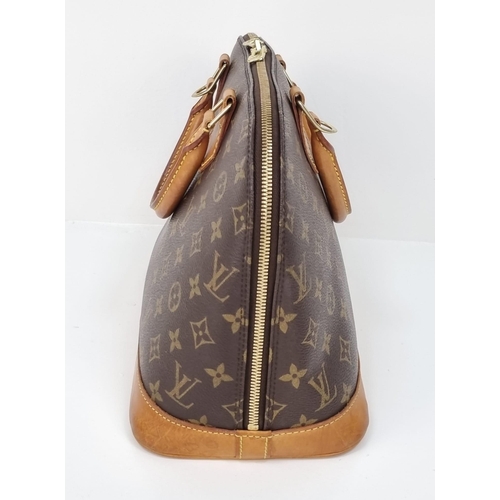 457 - A Louis Vuitton Monogram Canvas Hand Bag. Brown leather and gilded hardware. Cloth interior with ope... 