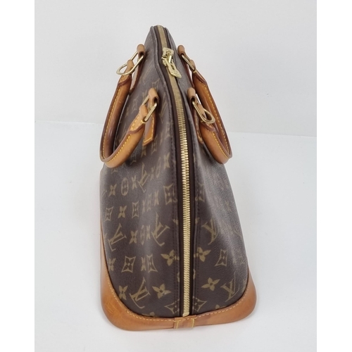 457 - A Louis Vuitton Monogram Canvas Hand Bag. Brown leather and gilded hardware. Cloth interior with ope... 