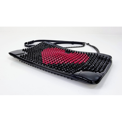 464 - A Christian Louboutin Patent Leather Valentine Clutch Bag.
Black and red exterior studs. Red cloth i... 