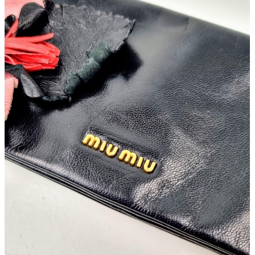 495 - A Miu Miu Black Leather Pencil Handbag. Zipped interior compartment. Comes with a Miu Miu bag. 23 x ... 