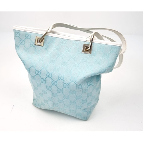 501 - A Baby-Blue Coloured Monogrammed Gucci Canvas Bag. White leather and silver-grey cloth interior with... 