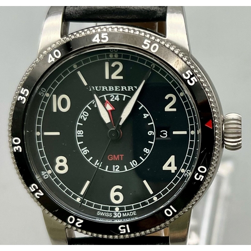 274 - A gents BURBURRY watch. Case diameter: 42 mm, black calibrated rotating bezel, black face with date ... 