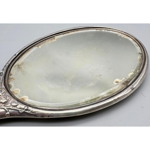 620 - An Antique Sterling Silver Hairbrush and Hand-Mirror. Repoussé floral decoration. Hallmarks for Birm... 