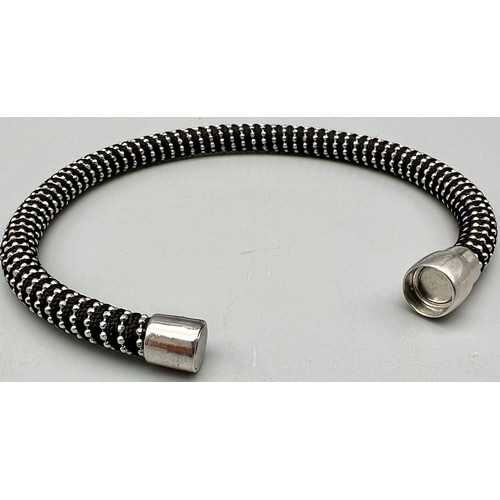 990 - STERLING SILVER WITH BLACK MATERIAL MAGNETIC CLASP BRACELET. 17CM LENGTH